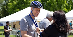 Matt Mercier receives a medal after participating in a Team NPF Cycle event. 