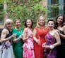 A group of women in floral dresses outside at an NPF cocktail event.