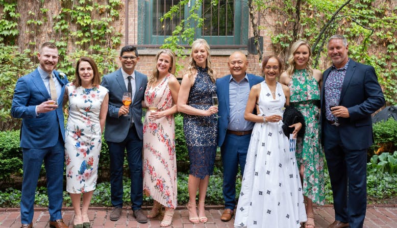 A group of beautifully dressed attendees at a 2023 Fleur de Cure event.