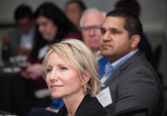 A woman sits with other participants as they listen to a training on advocacy.