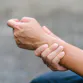 A person holding their wrist in pain.