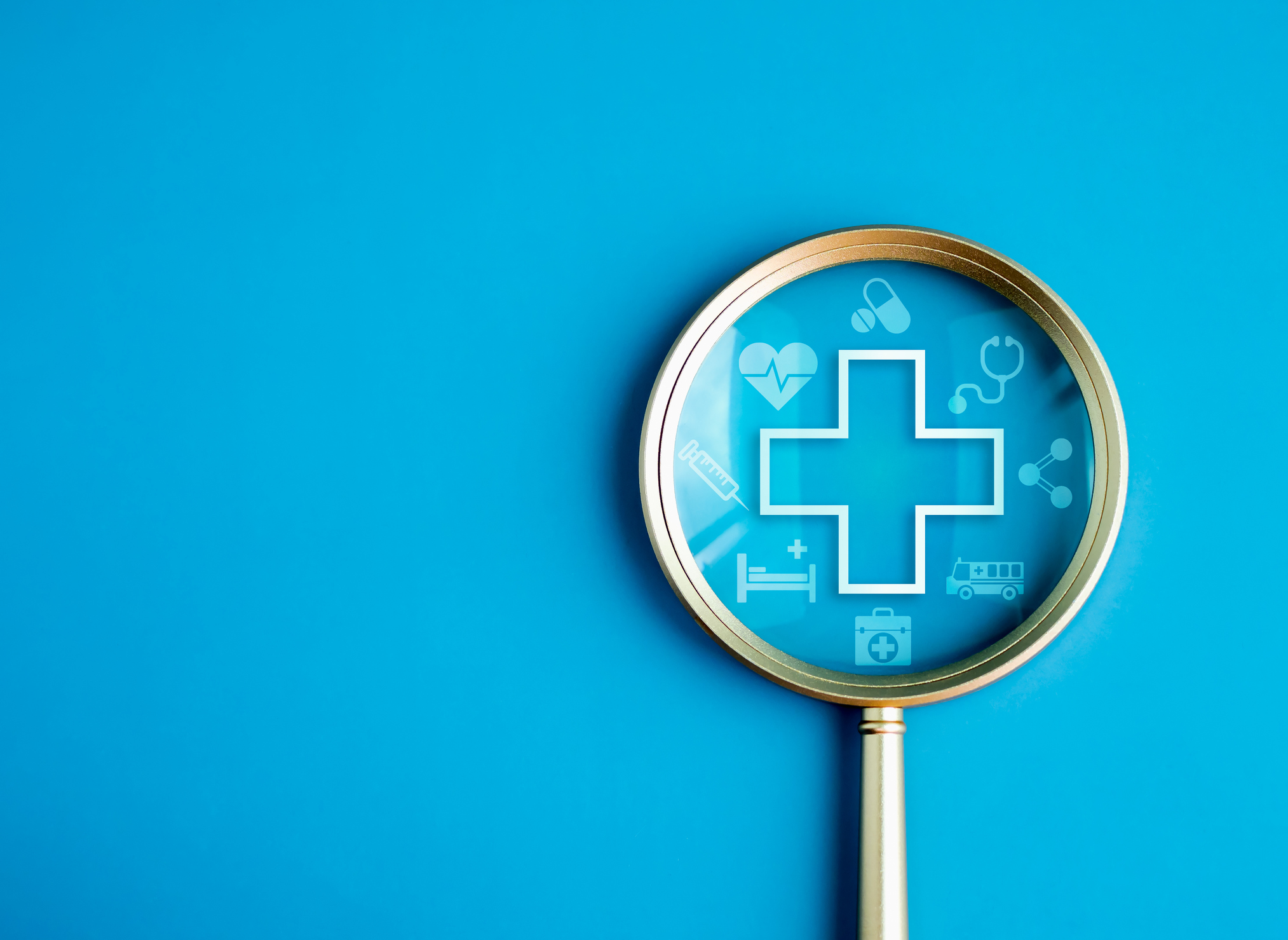 A magnifying glass and a health cross symbol