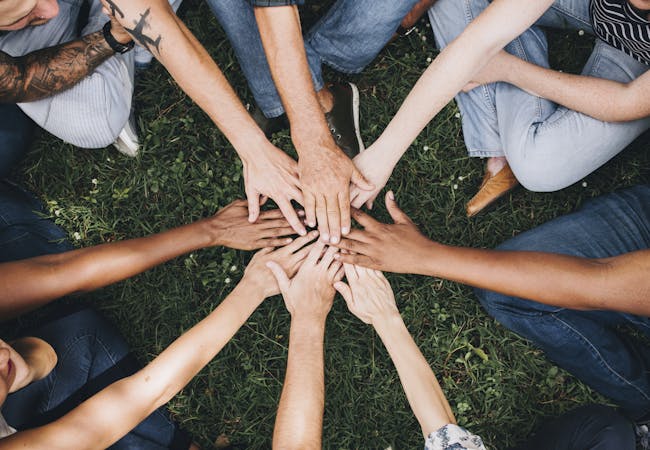 people in circle holding hands