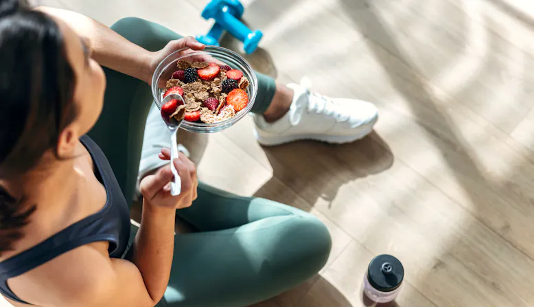 A woman eats after exercise