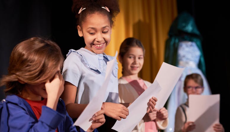 School age children rehearse a play