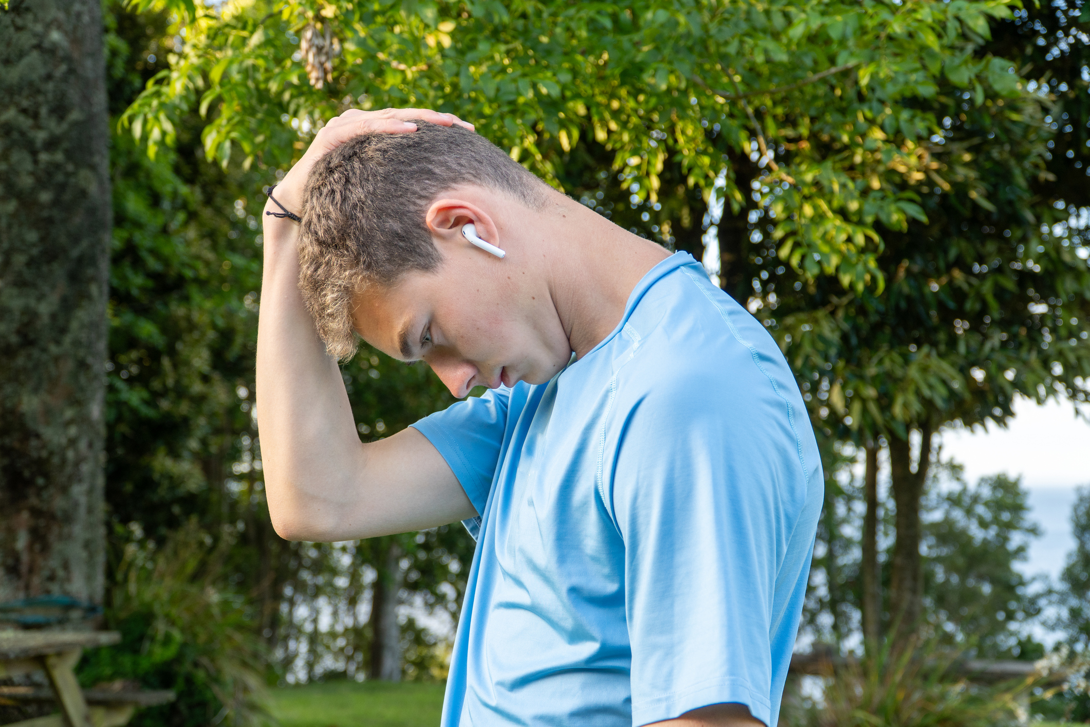 a young person listens to a podcast on ear pods