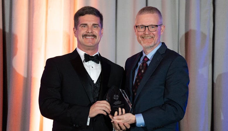 Colby Evans, M.D. receives an award.