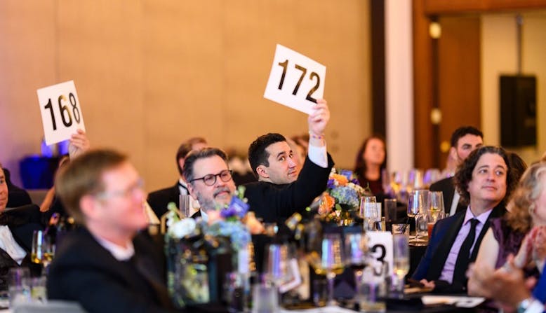 Attendees at the 2024 Commit to Cure Gala participate in the auction.