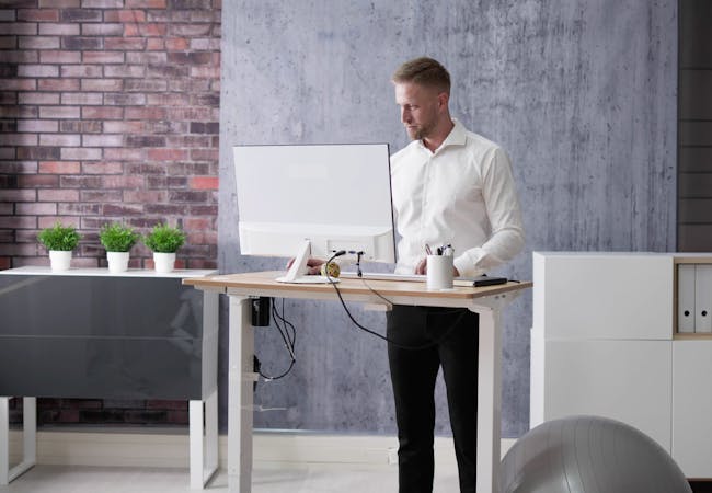 A man standing at a desk in an office.