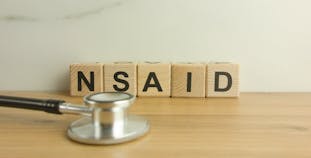 NSAID is spelled out in blocks with a stethoscope in front.