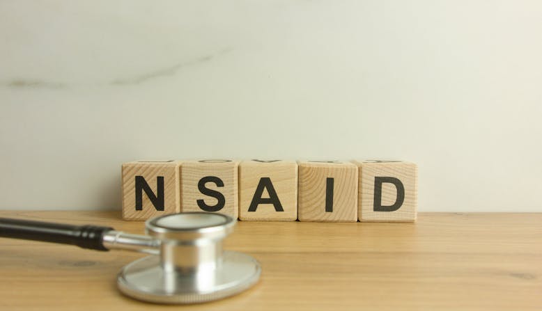 NSAID is spelled out in blocks with a stethoscope in front.