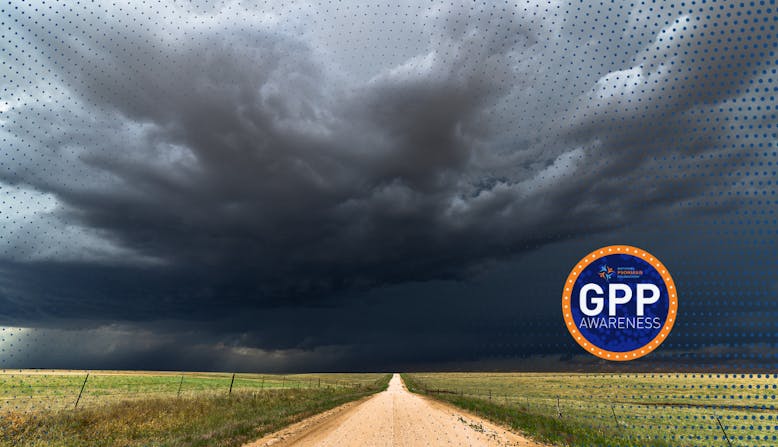 A road stretches into the distance with dark storm clouds overhead, with the GPP Awareness logo.