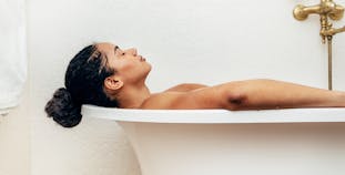 Woman relaxing in a bathtub.