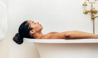 Woman relaxing in a bathtub.