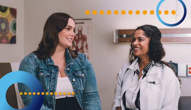 A patient talks with a doctor in an office.