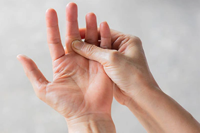 One hand holding the other in pain.