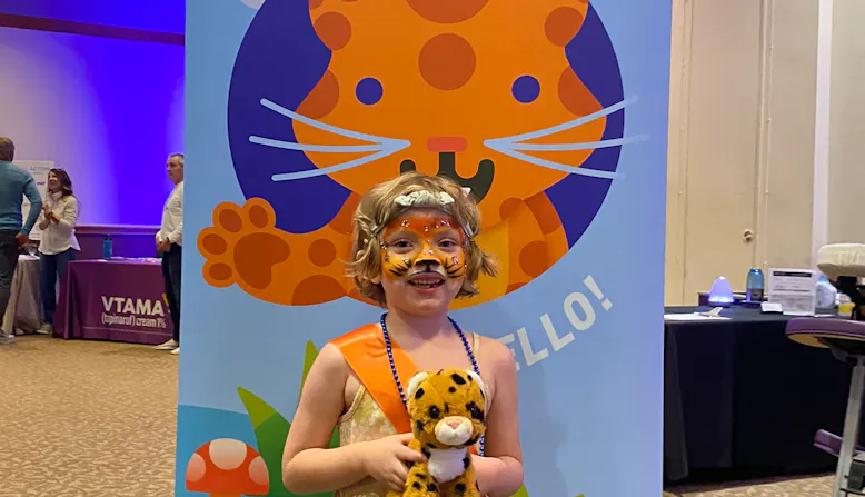 Colette Eide with Spot the leopard stuffy at the Portland Take ACTION event.