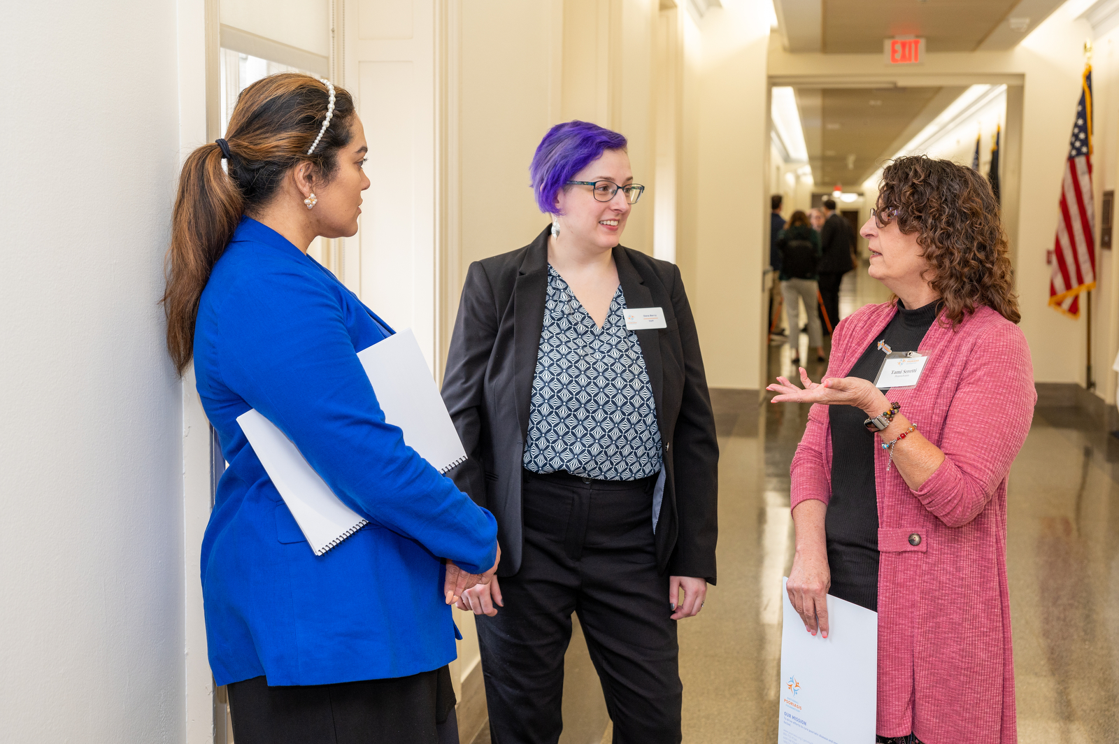 Seritta, Dana, and Tami discuss advocacy efforts in the halls of the Capitol building, in Washington, D.C.
