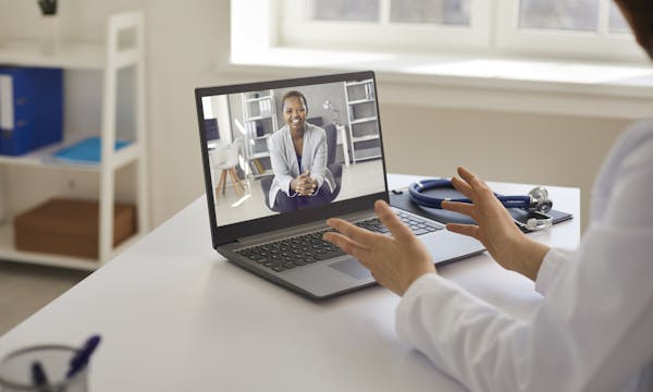 A doctor talks to a patient on the computer. Teledermatology.