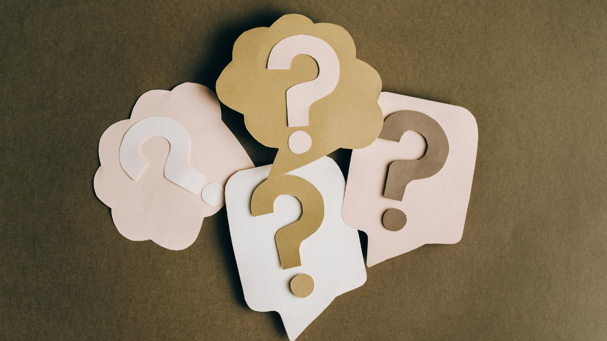 Question marks cut out of paper.