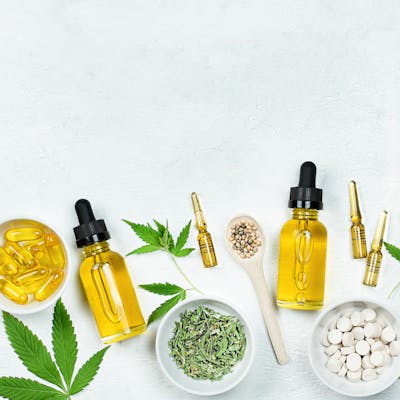 CBD oil, capsules, tablets, and cannabis leaves.
