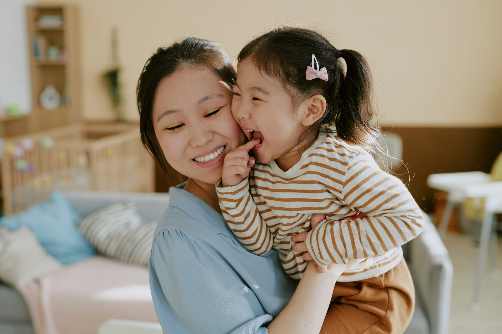 Mom and child smiling.