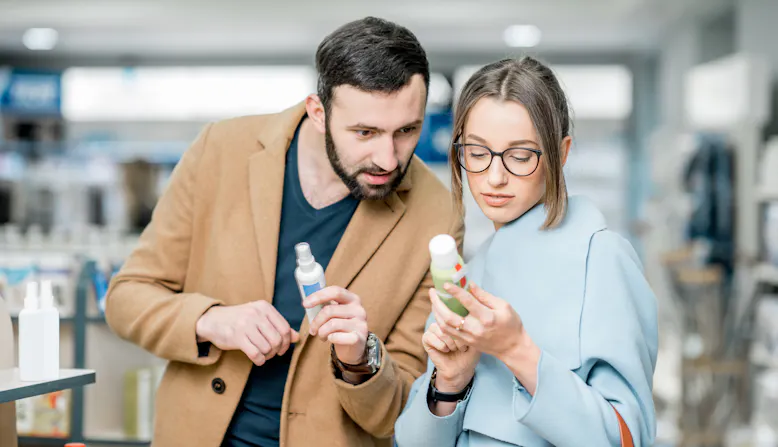 A woman and a man read the label on a over-the-counter product.