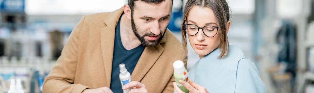 A woman and a man read the label on a over-the-counter product.