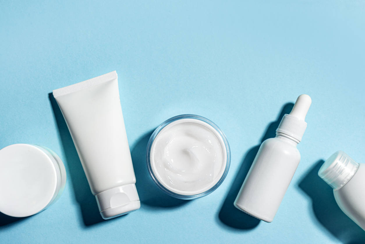 Lotions and cosmetic products on a blue background.