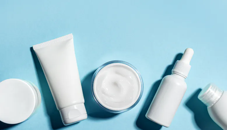 Lotions and cosmetic products on a blue background.