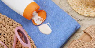 Sunscreen on a towel on the beach.