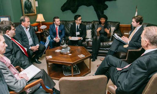 A group of advocates sit down and discuss in an office. 
