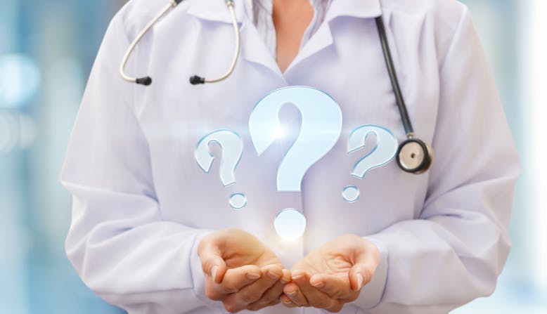 A woman doctor with a stethoscope holds her hands out and digital question marks are above.