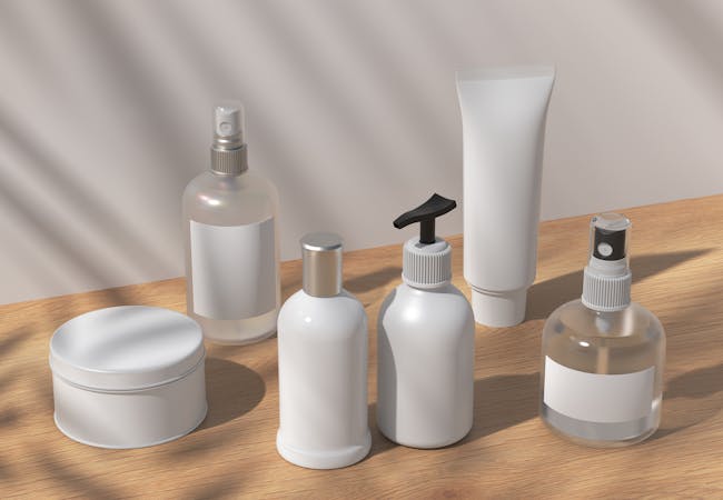 A collection of white lotion and spray bottles and containers.