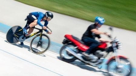 Team Novo Nordisk member and Olympic hopeful, Mandy Marquardt cycles behind a motorcycle on the t rack.