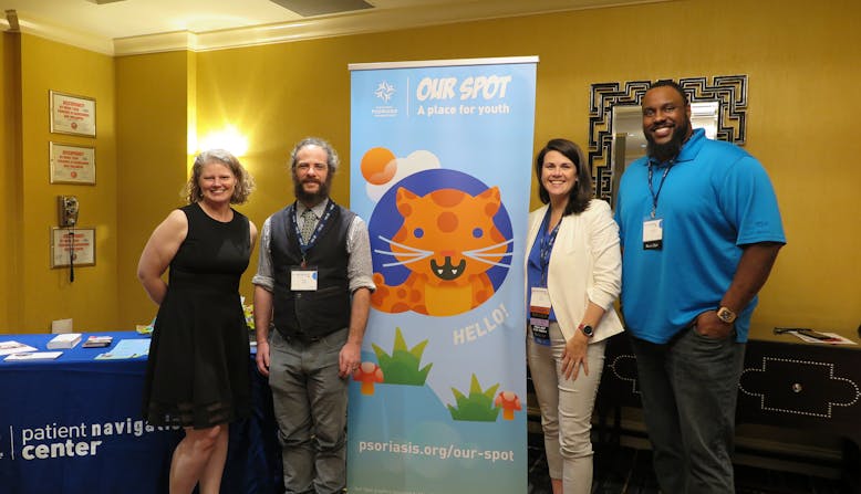 Jaime Lyn Moy, Miles Seiden, Leah Howard, Jonathan Scott standing next to the NPF Our Spot banner at the Healthier Together: Learning for All Ages conference.