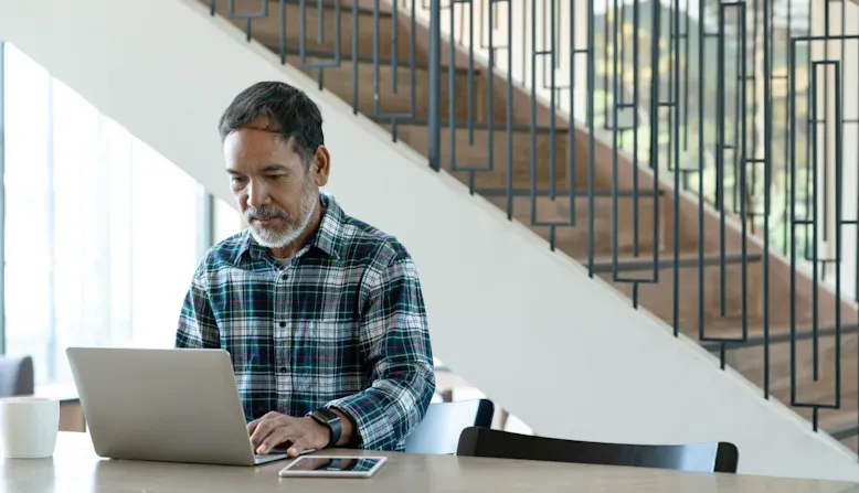 A man conducts research on a laptop.