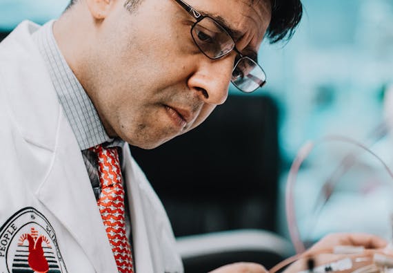 Close-up of a medical researcher observing equipment.
