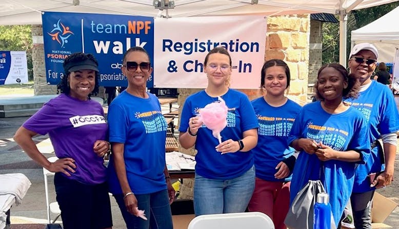 Volunteers at a Team NPF Walk registration and check-in table.