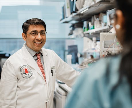 Dr. Mehta poses in a research lab.