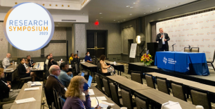 The audience and speaker Dr. Andy Blauvelt at the 2023 NPF Research Symposium: A Cure for All.