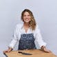 Michelle Bernstein with apron and chef's knife.