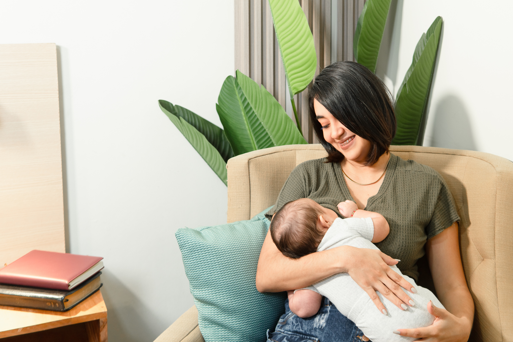 A woman breastfeeds an infant.