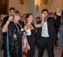 A group of people raising a toast at a fancy event.