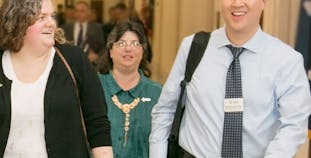 Wilson Liao and advocates walk together in a government building.