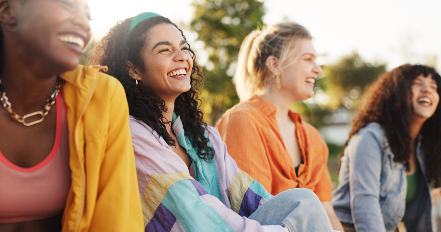 A group of women smiling outside.