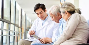 A doctor discusses treatment with a patient and his spouse.