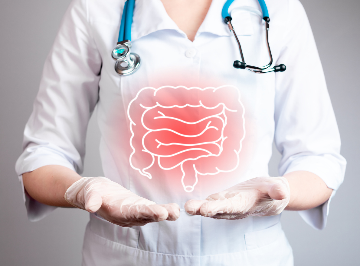 A doctor holding their hands out with a graphic of the intestines over them.