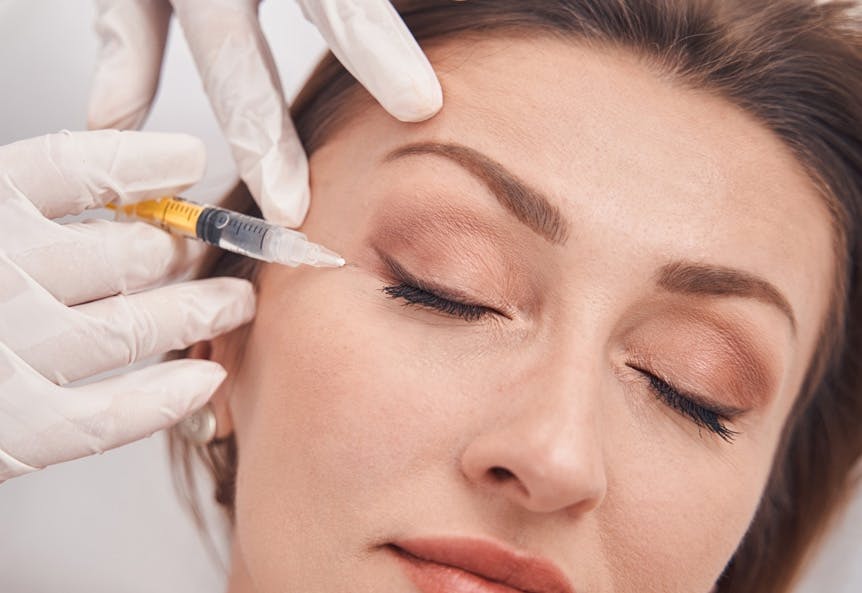 Mature woman having botox injection