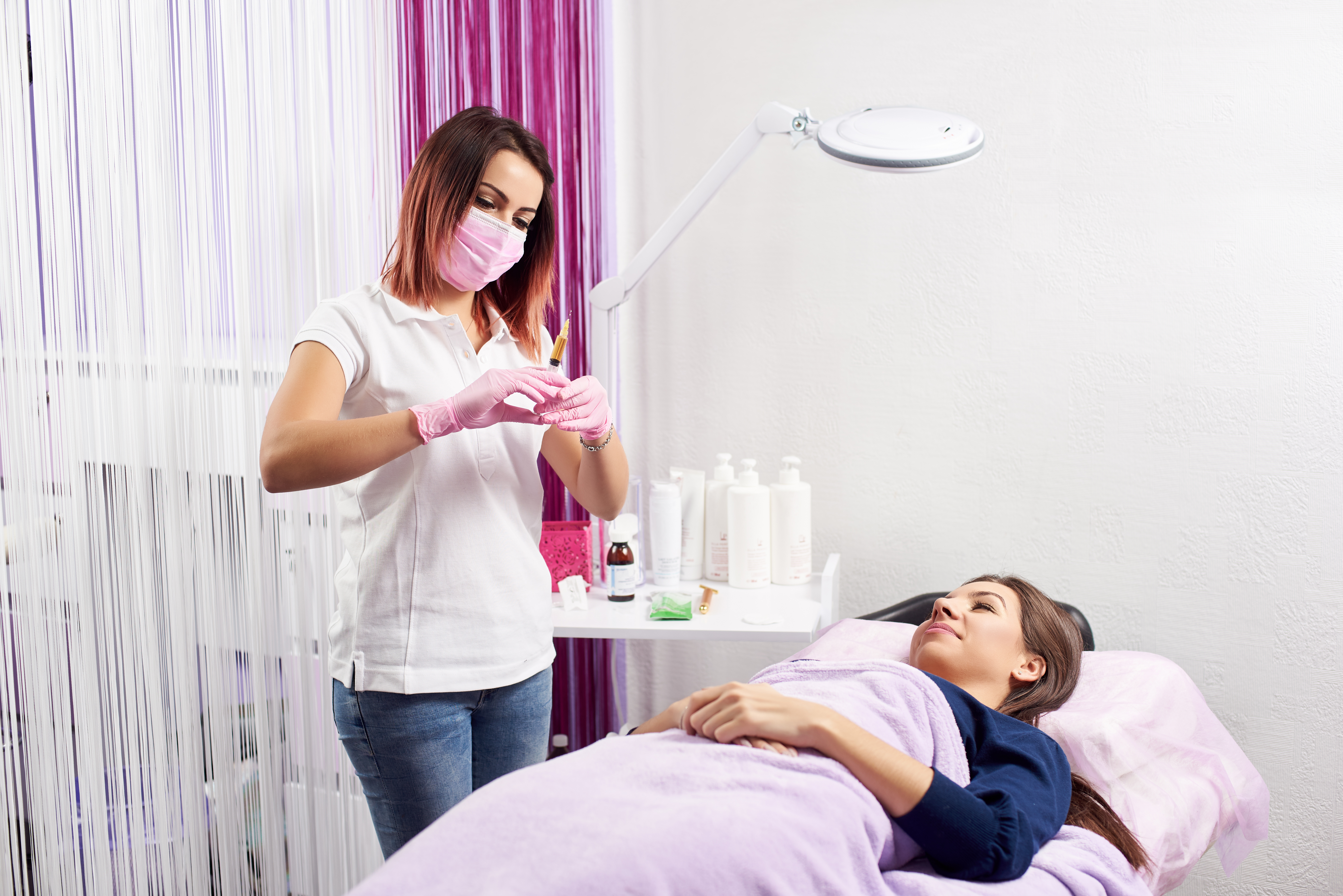 woman receiving botox treatment from a non-medical beauty therapist